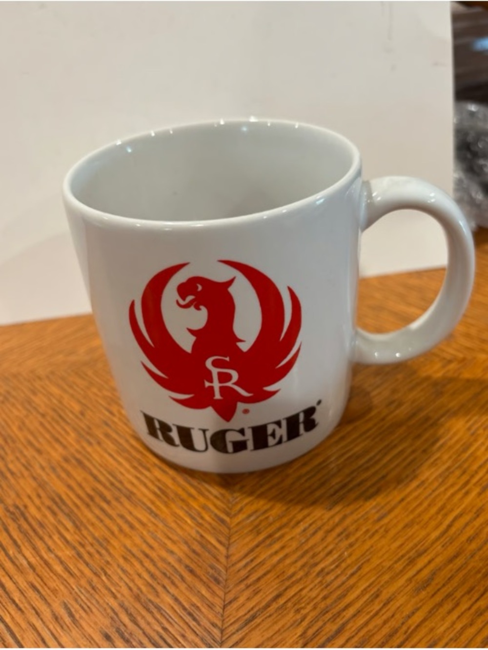 Kruger White Ceramic Mug with Red Emblem
